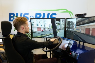 A man operates a bus simulator.
